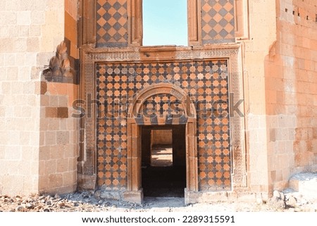 Experience the ancient wonders of Ani Ruins in Kars, Turkey with this stunning photo of Ani Seljuk palace entrance gate Discover history and culture in this scenic landmark.