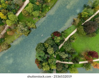 Experience a breathtaking aerial view showcasing a lush green park alongside a meandering river - Powered by Shutterstock