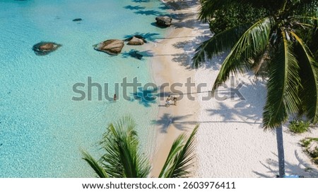 Experience the breathtaking overhead view of a tranquil beach and the stunningly crystalclear waters on Koh Kood Island, Thailand, an ideal destination for complete relaxation and escape