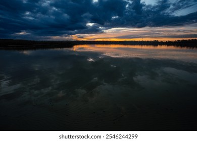 Experience the breathtaking serene sunset reflections over the tranquil waters at dusk - Powered by Shutterstock