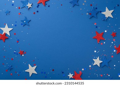 Experience the joy of Independence Day with this top-down view: glimmering stars and confetti, artfully arranged on a blue surface with a blank circle for text or promotion - Shutterstock ID 2310144535
