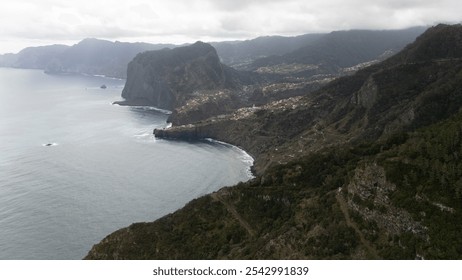 Experience the majestic beauty of rugged coastal cliffs and sweeping ocean views under a cloudy sky, capturing the essence of untouched natural landscapes. - Powered by Shutterstock