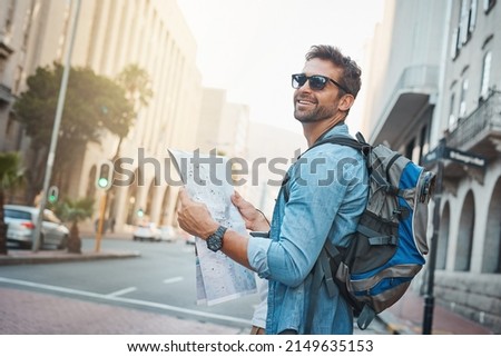 Experience the natural, cultural and man-made wonders of the world. Shot of a young man looking at a map while touring a foreign city.