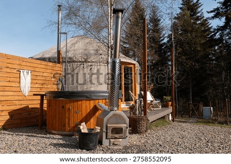 Experience nature in a unique yurt accommodation featuring a relaxing hot tub and a rustic outdoor setting