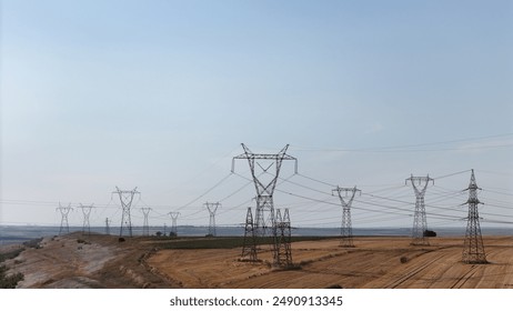 Experience the power of connectivity with this high-resolution stock photo of high voltage power lines. Ideal for energy sector projects, with ample space for adding text directly on the image