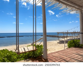 Experience pure bliss in the Mayan Riviera. This wooden beach bar offers the perfect spot to relax in a hammock, sipping on a tropical drink while gazing out at the stunning horizon. - Powered by Shutterstock