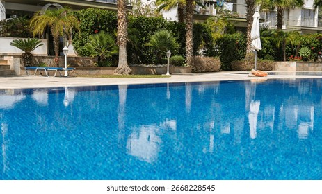 Experience the refreshing allure of this inviting swimming pool surrounded by lush greenery. Ideal for vacation rentals, promoting relaxation and leisure in a serene atmosphere.