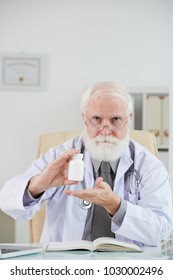 Experienced Aged Doctor Showing New Revolutionary Medicine