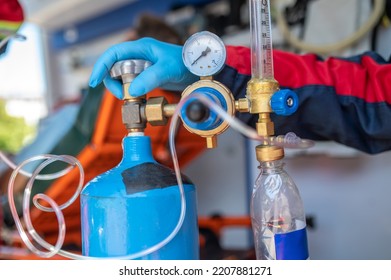 Experienced Ambulance Doctor Preparing The Medical Equipment For Oxygen Therapy