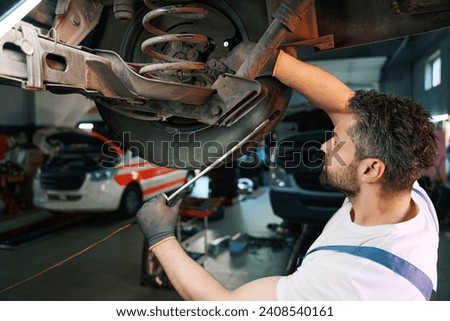 Experienced auto mechanic performing customer car inspection