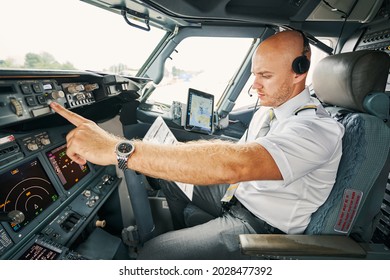 Experienced aviator checking flight controls before the departure - Powered by Shutterstock