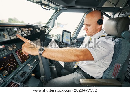 Experienced aviator checking flight controls before the departure