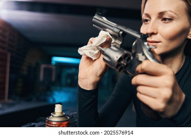 Experienced Caucasian Female Sniper Cleaning Her Revolver