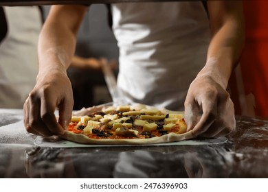 experienced chef - process of making pizza. Professional chef prepares the dough with flour to make pizza or pasta Italian food