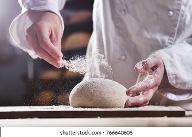 An experienced chef in a professional kitchen prepares the dough with flour to make the bio Italian pasta. the concept of nature, Italy, food, diet and bio. - Powered by Shutterstock