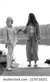  An Experienced Coach Helps The Girl Stand Barefoot On A Board With Nails. It Is Better If Someone Helps You Stand Up, Holding Hands. Board With Nails.