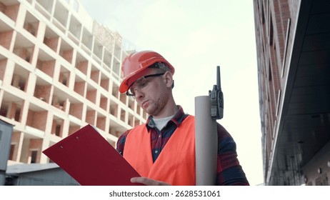 Experienced construction superintendent making notes during site inspection