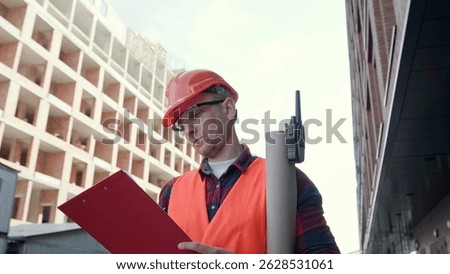 Experienced construction superintendent making notes during site inspection