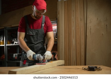 An experienced craftsman focuses on processing a piece of wood in a well-equipped workshop using a grinding machine - Powered by Shutterstock