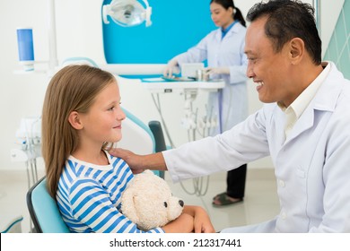 Experienced Dentist Supporting His Young Patient, Side View