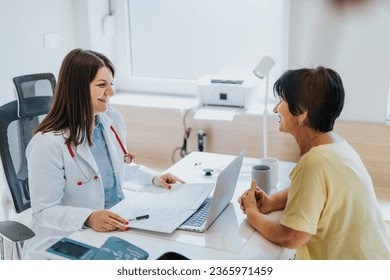 Experienced doctor analyzing test results and discussing diagnosis with elderly patient in medical office. Careful communication provides satisfied and positive experience for patient. - Powered by Shutterstock