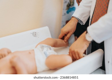 Experienced doctor pediatrician examining little baby at modern clinic. Baby health care concept. - Powered by Shutterstock