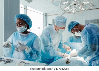 Experienced Doctors Performing Organ Removal Or Transplant In The Clinic.