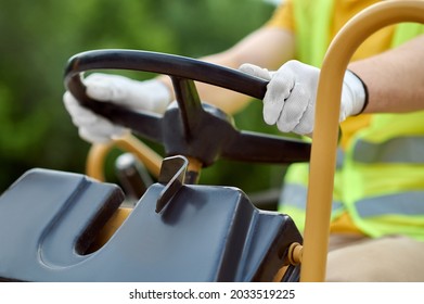 Experienced Driver In Gloved Hands Seated At The Steering Wheel