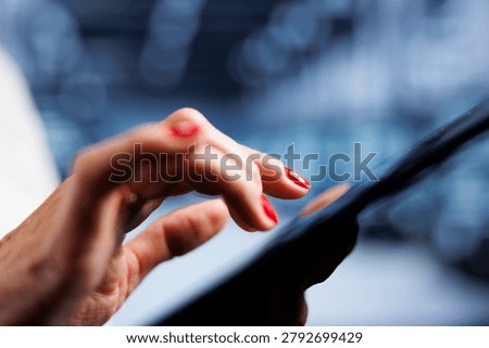 Experienced employee using tablet, ensuring valuable data remains shielded from potential security problems, safeguarding server rows against unauthorized access and vulnerabilities, close up