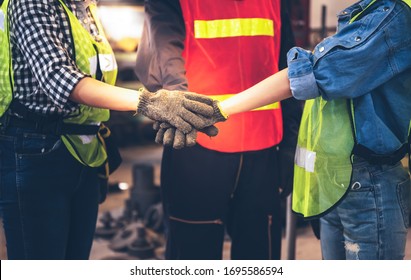 Experienced entrepreneurs, engineers man and woman are join hands to show their cooperation For success teamwork, with blur soft of industrial machinery background, to people and synergy concept. - Shutterstock ID 1695586594