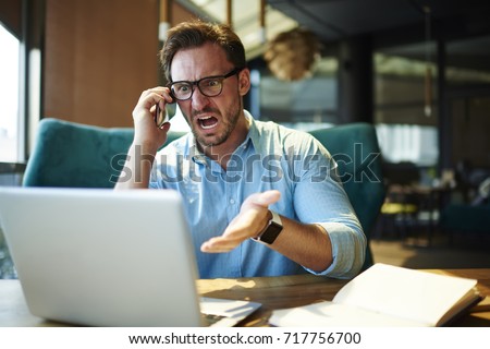 Experienced executive manager quarreling with employee on mobile yelling and screaming  about bad report and failure with project, mad boss angry about software bugs in application for work
