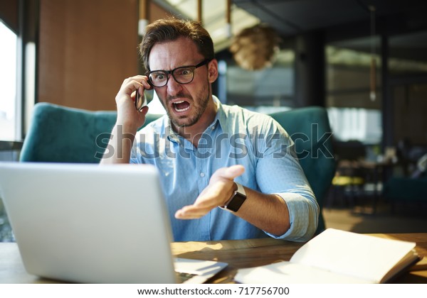 Experienced executive manager quarreling with\
employee on mobile yelling and screaming  about bad report and\
failure with project, mad boss angry about software bugs in\
application for\
work\
