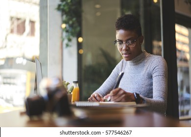 Experienced Female Editor Of Fashion Magazine Working On Creation Of Book Review Writing  Best Ideas Into Notebook Before Publishing On Web Page Of Issue Online Version Sitting In Modern Cafe 