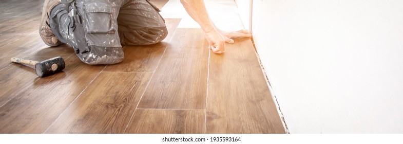 Experienced Floor Layer Is Laying A New Vinyl Flooring Design