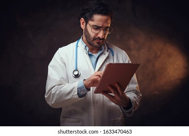 Experienced Focused Medic Is Checkin Perscription For Medication On The Tablet.