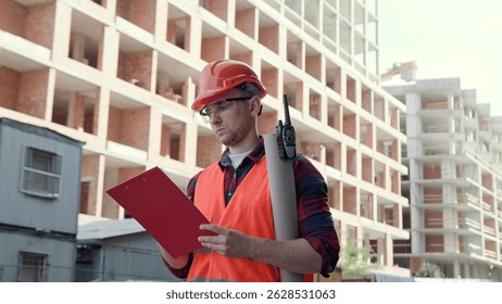 Experienced foreman taking notes during building site inspection