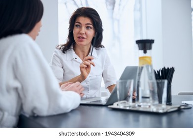 Experienced General Practitioner Consulting Her Female Patient