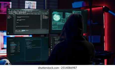 Experienced hacker writing lines of code on computer from underground bunker, tying to get past security systems. Rogue programmer building scripts that can hack devices, camera A