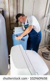 Experienced home installer with a new water softener trying to solve installation problems in a basement utility room