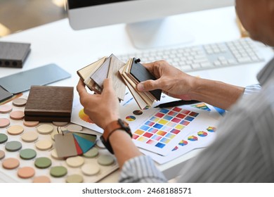 Experienced Interior designer holding color samples working on new design project at office - Powered by Shutterstock