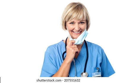 Experienced lady doctor removing her surgical mask - Powered by Shutterstock