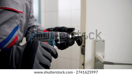 The Experienced Locksmith Expertly Replacing A Damaged Door Lock.