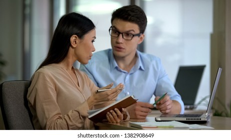 Experienced male employee teaching new colleague, business cooperation, work - Shutterstock ID 1382908649