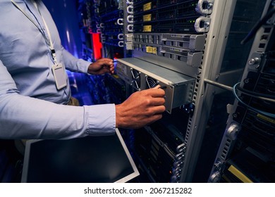 Experienced Male Engineer Replacing Network Server Components