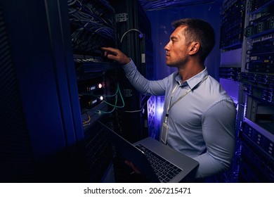 Experienced IT male technician monitoring server performance