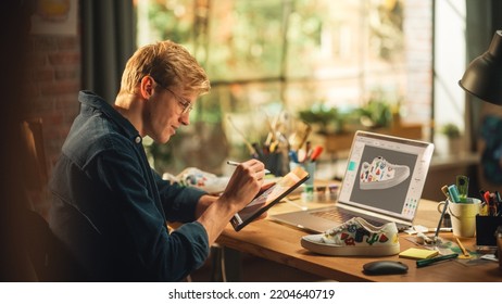 Experienced Male Teen Designer Works With Digital Graphics Tablet Touchscreen, Drawing Sketch of a New Unique Shoes Design. 3D Prototype of his Product in Editing Software on Laptop Display. - Shutterstock ID 2204640719