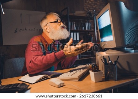 Experienced man using a retro computer in a cozy office, engaged in programming and remote work, representing mature freelancing