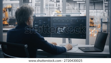 Experienced Manager Performs Remote Maintenance and Diagnosis of Industrial Equipment Using Dual Screen Workstation in Modern Data Center. Concept of Predictive Maintenance and Expert Control.