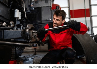 Experienced mechanic changing wheels on tractor. Service and maintenance of agricultural machinery. - Powered by Shutterstock