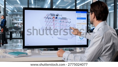 Experienced Mechanical Engineer Inspects 3D HVAC System Model On Wide Touchscreen.